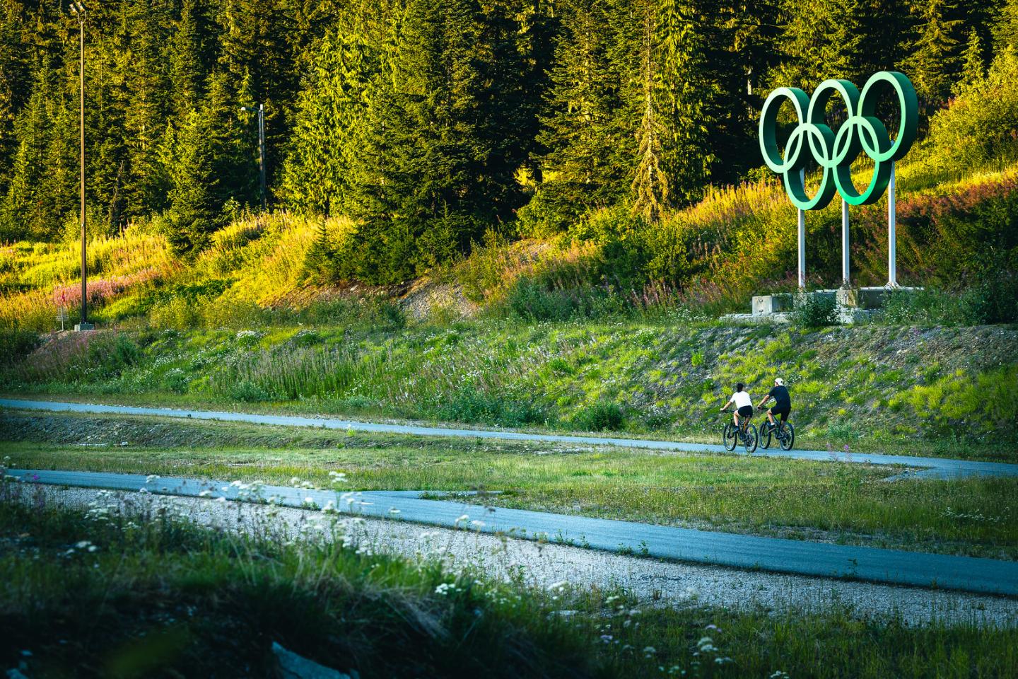 Bikers riding past Olympic Rings
